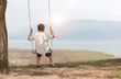 © kwanchaichaiudom - child sit on swing seat,  leisure concept