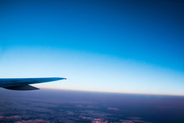 The wing of an airplane flying in the sky