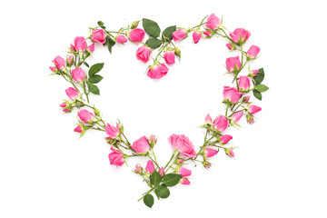 Small pink roses in the shape of heart on a white background