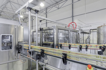 Sticker - conveyor belt in motion at production and bottling of drinks in tin cans. production and bottling of drinks in tin cans