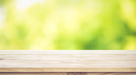 Empty wood table top on blur abstract green garden in the morning.For montage product display or key visual layout