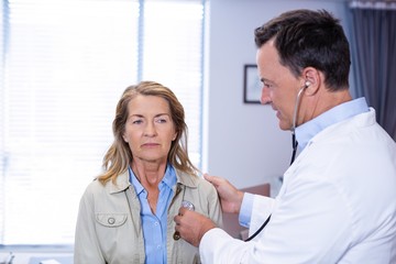 Wall Mural - Doctor examining a senior woman