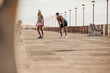 Young couple about to run on the promenade