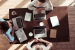 © LIGHTFIELD STUDIOS - overhead view of businesswomen working at table on new business project