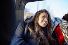 Smiling Young Woman In Back Seat Of Car