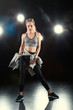 © LIGHTFIELD STUDIOS - dancing woman in sportive clothing on black