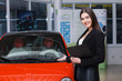 © aemstock - Beautiful female seller shows the car