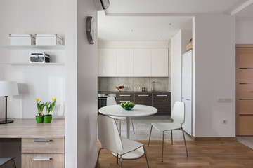 Interior of modern apartment in scandinavian style with kitchen and workplace.