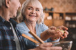 © LIGHTFIELD STUDIOS - portrait of happy senior couple making salad together in kitchen
