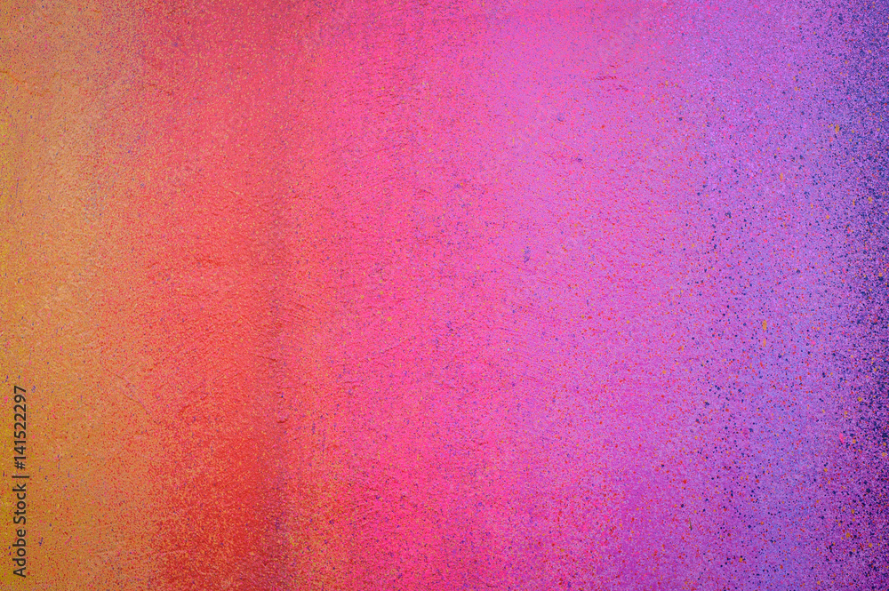 Part of a stone wall with colorful paint marks, paint texture, paint sprayed wall with colorful stains and flowing paint
