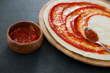 Pizza dough with tomato sauce