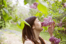 Woman Smelling Lilac Blossom