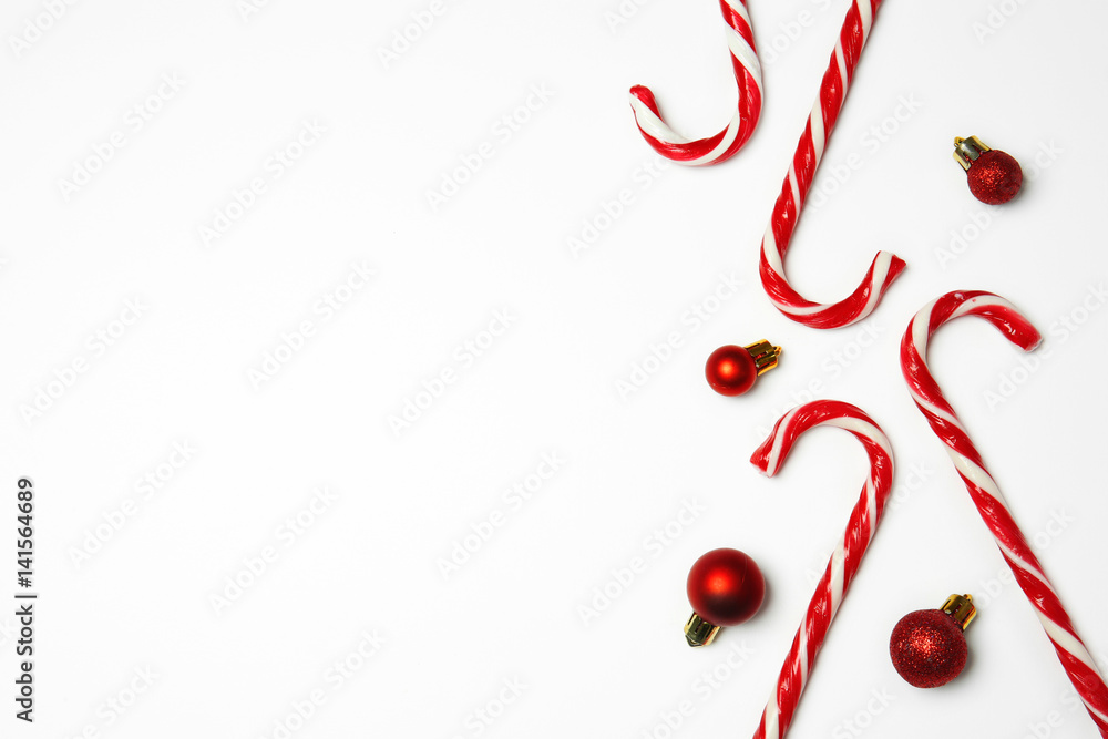Candy canes and Christmas decorations on white background