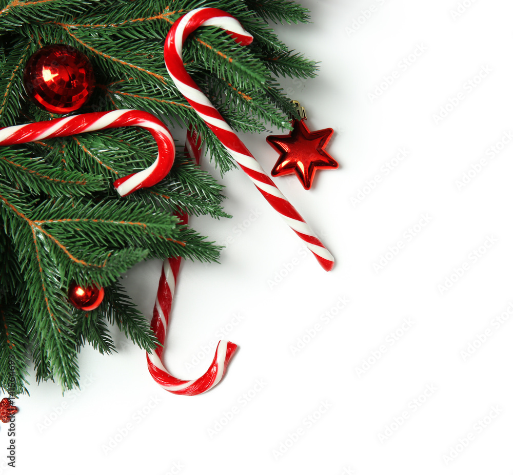 Candy canes and Christmas decorations on white background