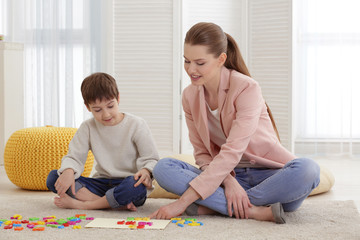 Wall Mural - Cute little boy at speech therapist office