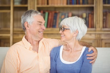 Wall Mural - Senior couple sitting together on sofa in living room