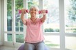 © WavebreakMediaMicro - Senior woman exercising with dumbbells at home