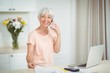 © WavebreakMediaMicro - Portrait of senior woman talking on mobile phone in kitchen