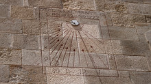 Close View Of A Sundial On A Wall A Sunny Day At Fort Montjuic In Barcelona, Spain