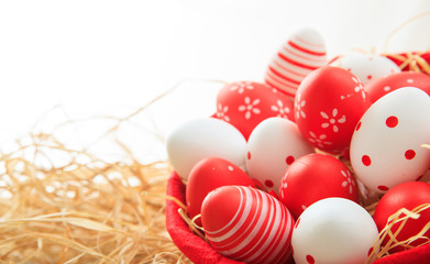 Easter eggs on straw background