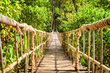 Fototapeta Most - Scenic simple suspension bridge over gorge
