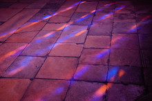 Divine Light In Temple. Stained Glass Reflection.  Colorful Light Spots On The Tiled Floor In The Church. Sunlight Filtered Through The Stained Glass Window.