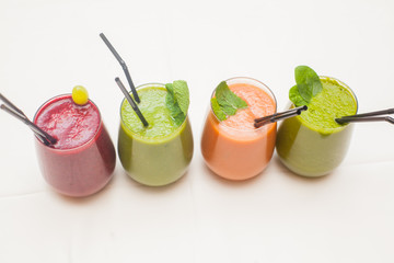 Red and green healthy smoothies on table.