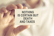© stanciuc - Businessman holding NOTHING IS CERTAIN BUT DEATH AND TAXES message card