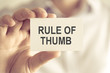 © stanciuc - Businessman holding RULE OF THUMB message card