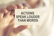 Businessman holding ACTIONS SPEAK LOUDER THAN WORDS message card