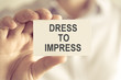 © stanciuc - Businessman holding DRESS TO IMPRESS message card