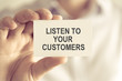 © stanciuc - Businessman holding LISTEN TO YOUR CUSTOMERS message card