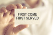 © stanciuc - Businessman holding FIRST COME FIRST SERVED message card