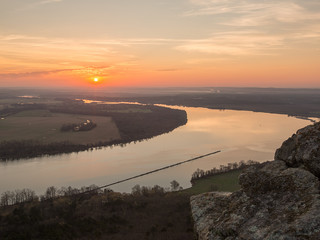 The sun rising lighting up the river valley on an early spring morning with calm water 