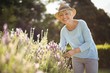 © WavebreakMediaMicro - Happy senior woman standing in backyard