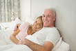 © WavebreakMediaMicro - Senior couple embracing on bed