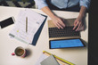 © Cavan Images - Overhead view of businesswoman using laptop in office