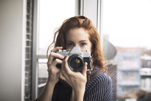 Portrait Of Woman Holding Digital Camera