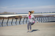 © nikodash - Morning exercise along the river. A young woman on recreation and jogging