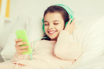 Poster - happy girl lying in bed with smartphone at home