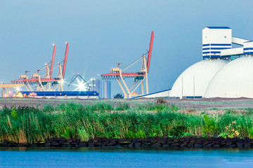 Wall Mural - Riga fertilizer terminal with saltpeter against river coast