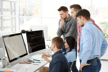 Young programmers working in office