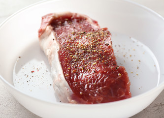 Canvas Print - Raw steak with spices on plate