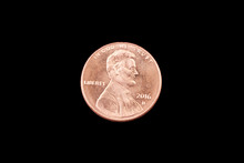 A Close Up Image Of An American One Cent Coin On A Black Background