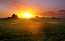 Mountains With Setting Sun And Forest Foreground, Queensland, Australia.