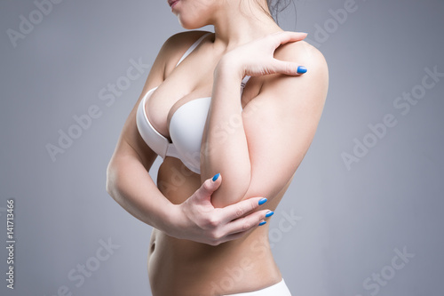 Cuadros en Lienzo Woman in white push up bra on gray background, perfect female breast