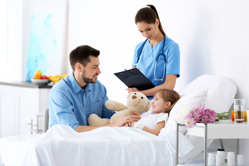 Father visiting little daughter in hospital