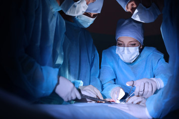 Canvas Print - Surgeons operating patient in clinic