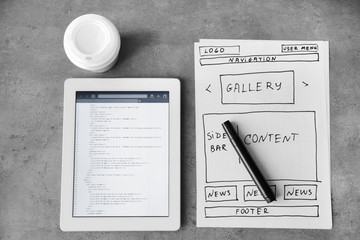 Tablet with programming code for website on table