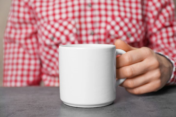 Sticker - Woman holding blank cup, closeup